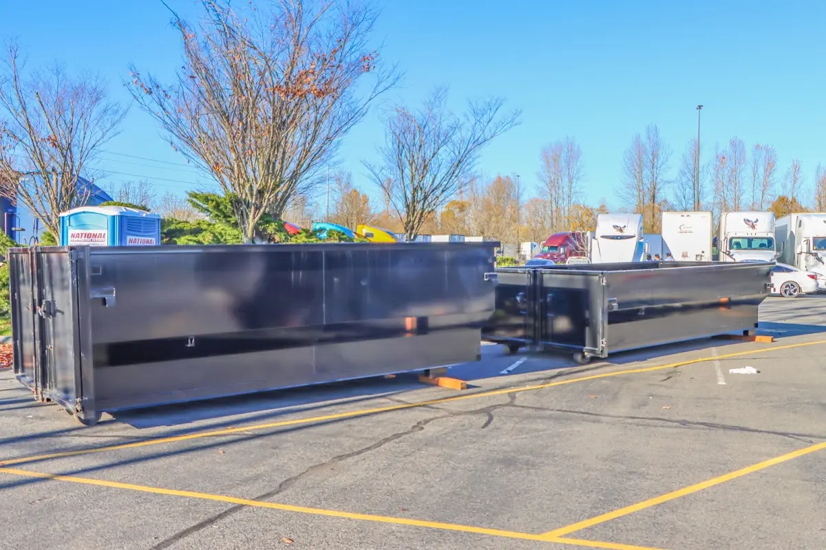 Professional dumpster rental service with roll-off container on residential driveway in Chico